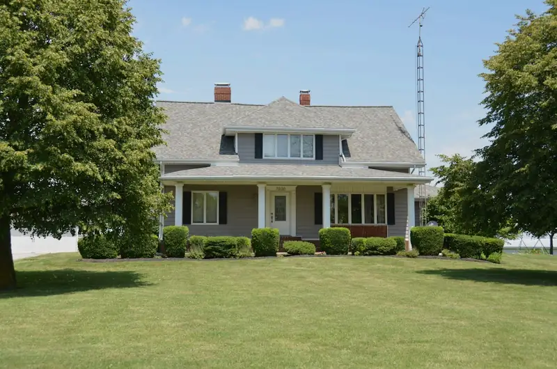 Single-family home with a front porch and green lawn